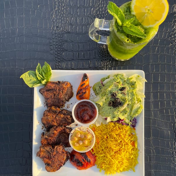 Hala Cafe's grilled lamb chops with yellow rice, salad, hummus, and a green mint drink.